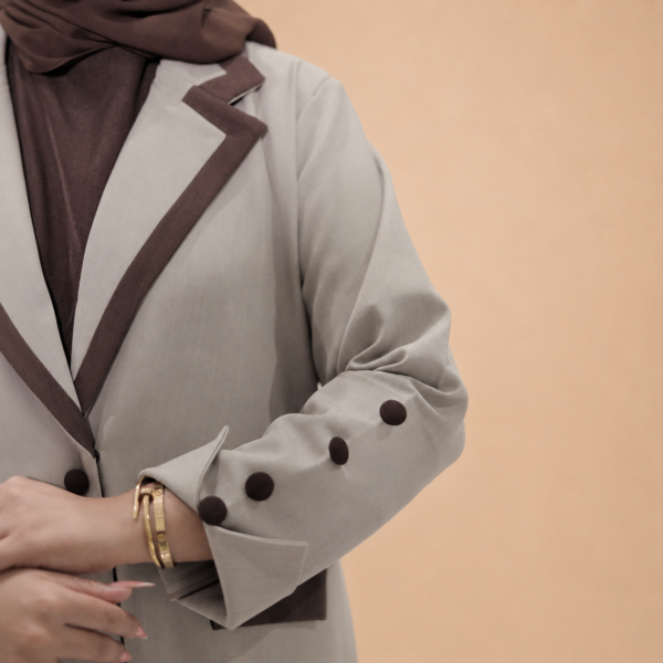 تفاصيل الياقة البنية وأزرار كم عباية السفر